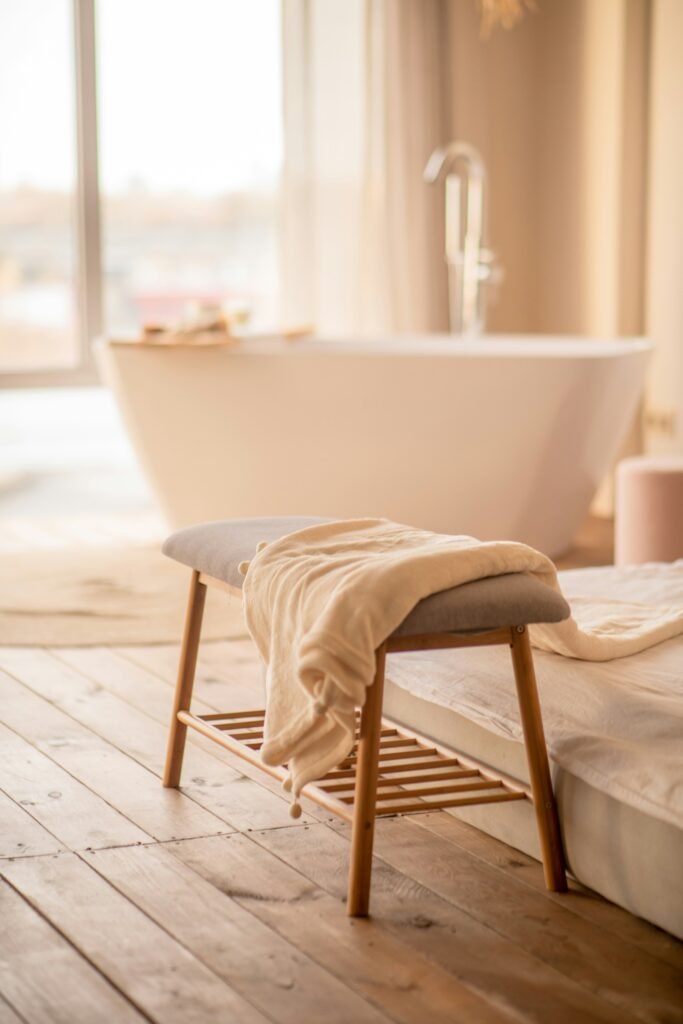 a white bath tub sitting next to a wooden floor a white bath tub sitting next to a wooden floor